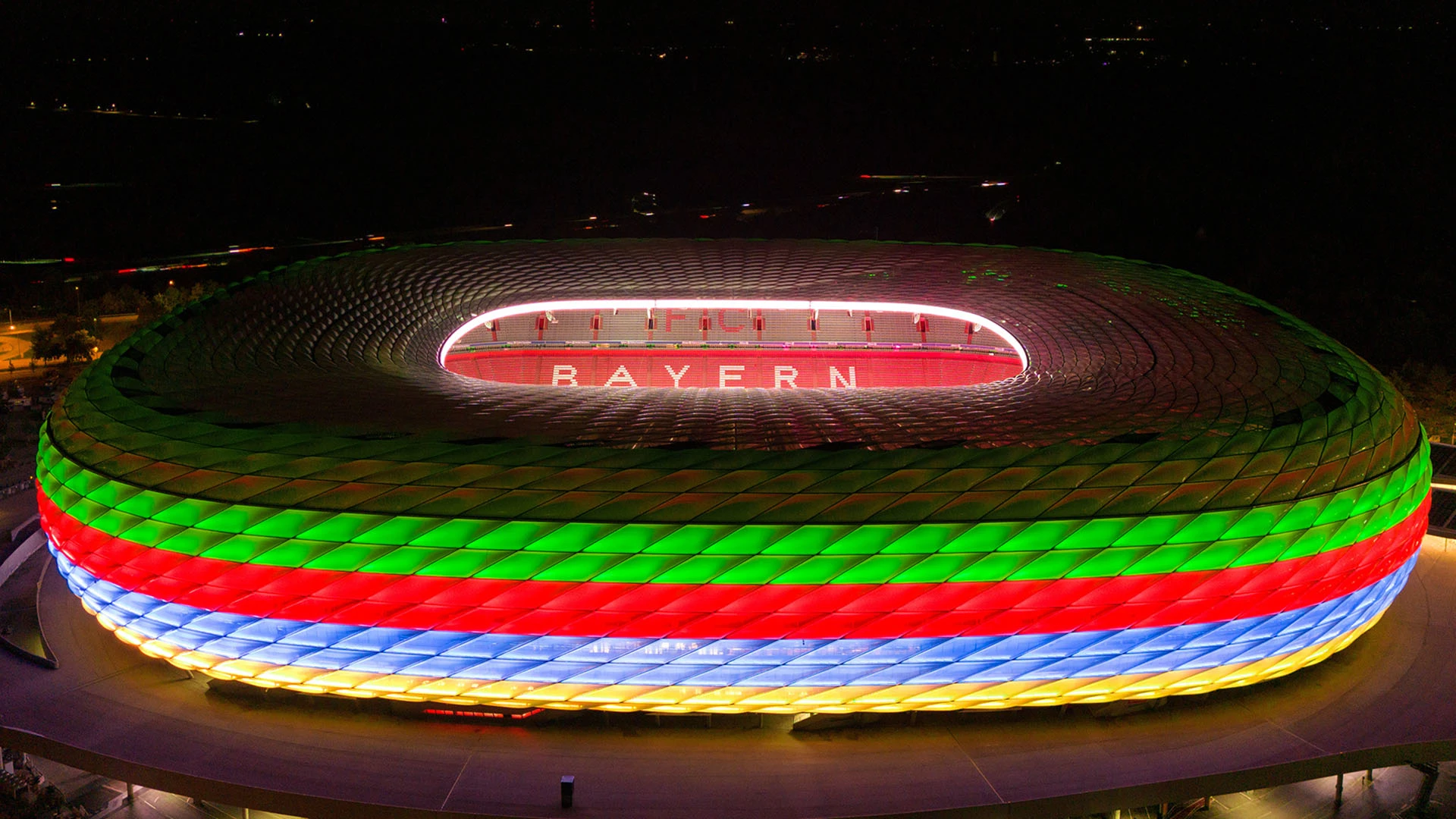 The Allianz Arena illuminated overnight in the colours of the German Olympic bid with black green, red, blue and yellow horizontal stripes on the facade