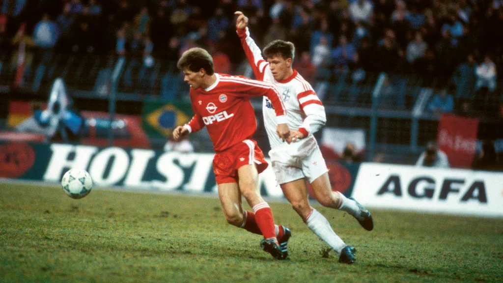 Stefan Reuter (FC Bayern) tussles with Leverkusen’s Knut Reinhard
