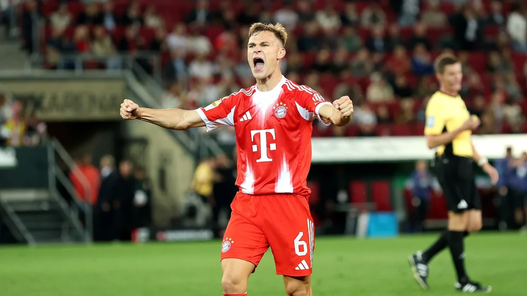 Joshua Kimmich celebrates at full time in Bayern's 3-2 win at Augsburg.