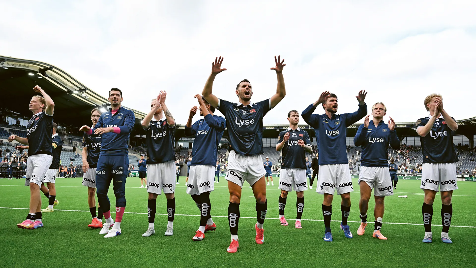 Viking players celebrating and waving to the fans
