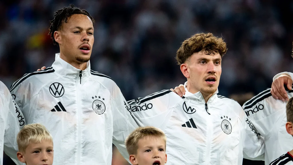 Derry Scherhant and Philipp Treu sing the national anthem before a Germany international