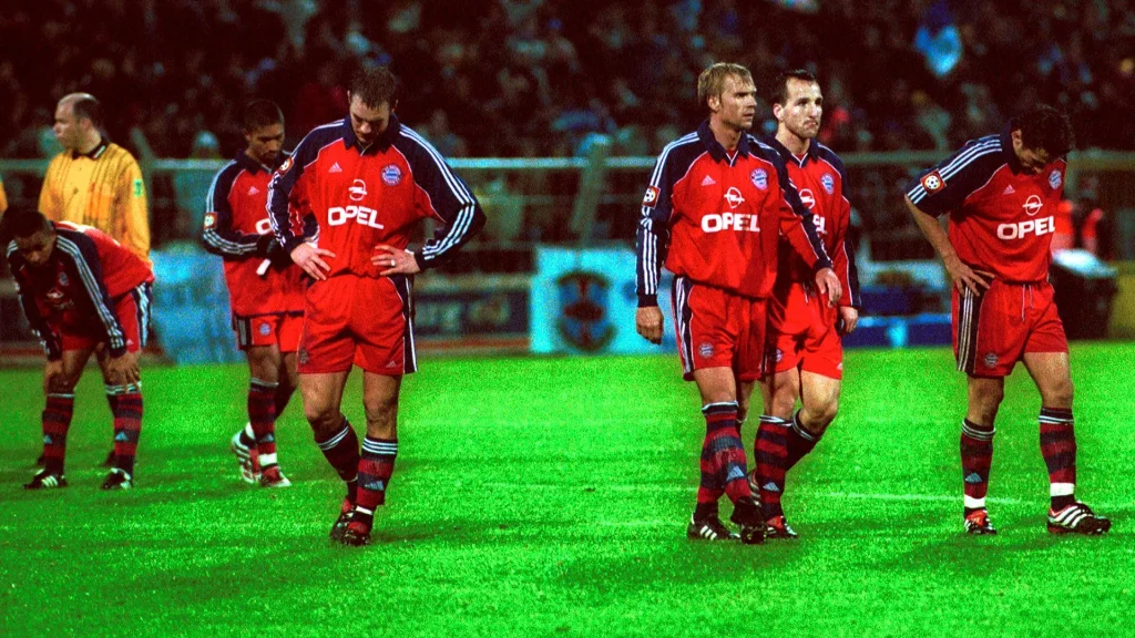 The Bayern players walk off the pitch disappointed after the defeat at Magdeburg in 2000