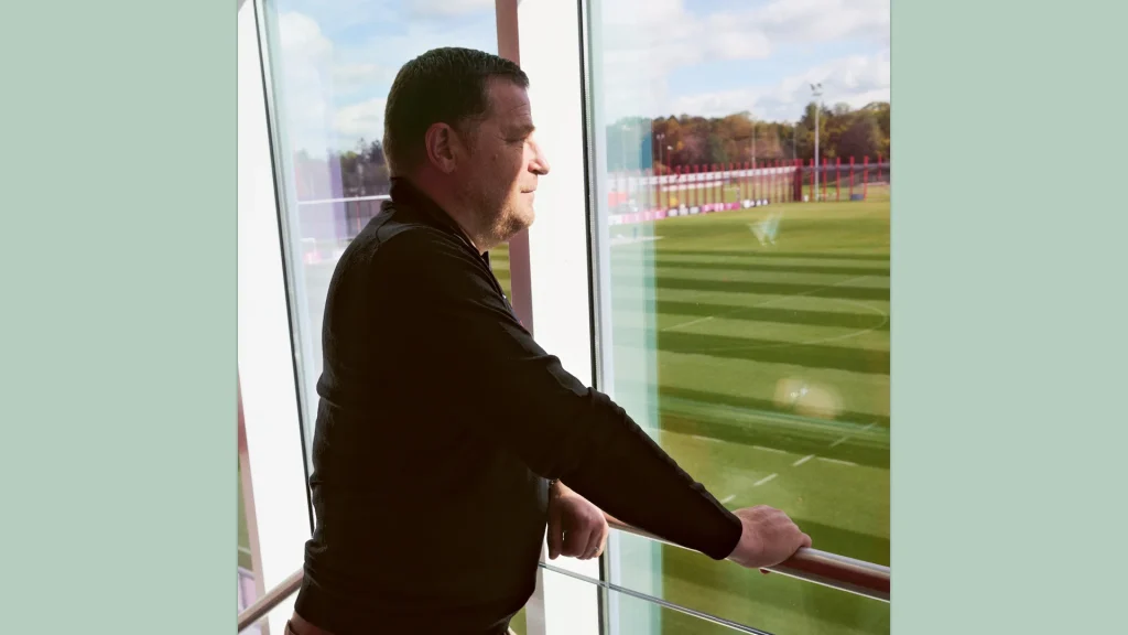 Max Eberl looks out of the window overlooking the training grounds on Säbener Straße