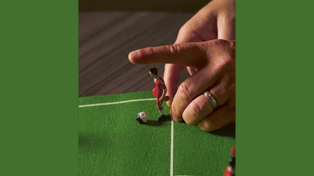 A hand making a move in table football